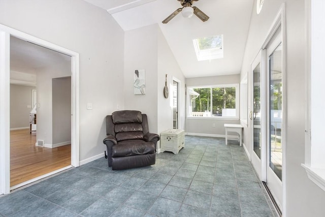 7 Cornish St, Carver, MA 02330 - living area featuring vaulted ceiling, a ceiling fan, a skylight, and baseboards