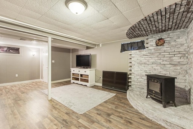 7 Cornish St, Carver, MA 02330 - finished below grade area with wood finished floors, baseboards, and a wood stove