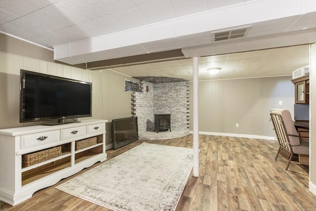 7 Cornish St, Carver, MA 02330 - living area featuring wood finished floors, a wood stove, baseboards, and crown molding