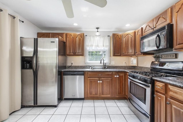 7 Cornish St, Carver, MA 02330 - kitchen with stainless steel appliances, dark countertops, a sink, ceiling fan, and light tile patterned flooring