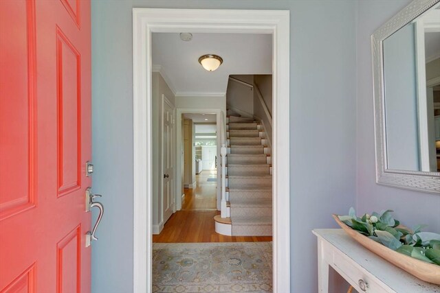 entrance foyer with stairway and ornamental molding