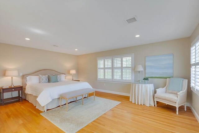 bedroom with recessed lighting, light wood-type flooring, visible vents, and baseboards