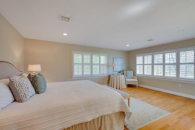 bedroom featuring recessed lighting, visible vents, baseboards, and wood finished floors