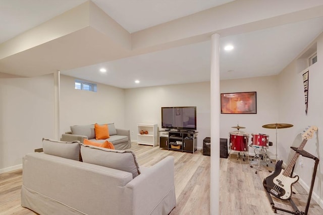 living area featuring baseboards, light wood-type flooring, visible vents, and recessed lighting