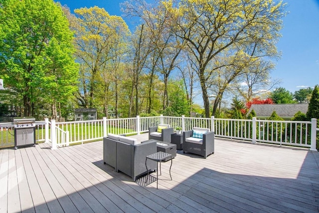 wooden deck featuring an outbuilding, area for grilling, and an outdoor living space