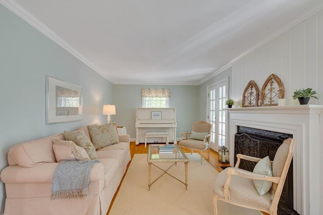 living room with ornamental molding, a fireplace, and wood finished floors