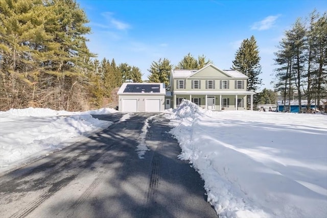 view of front of property featuring covered porch and a garage