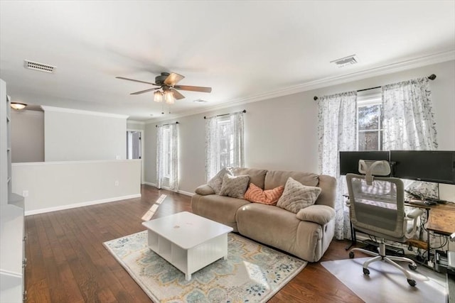 living room with dark hardwood / wood-style flooring, ceiling fan, and crown molding