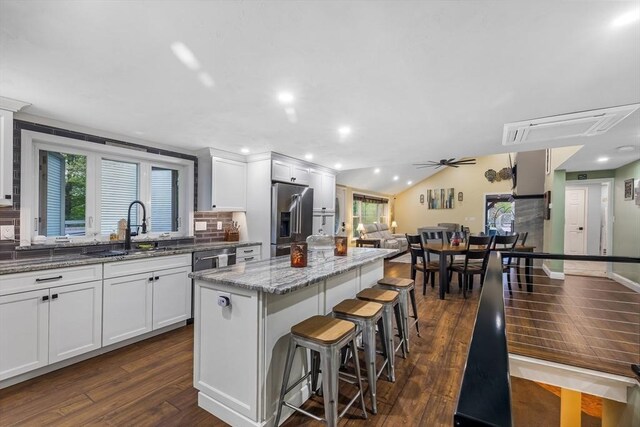 8 New Spencer Rd, Charlton, MA 01507 - kitchen with stainless steel refrigerator with ice dispenser, a sink, a center island, a ceiling fan, and dark wood-style flooring