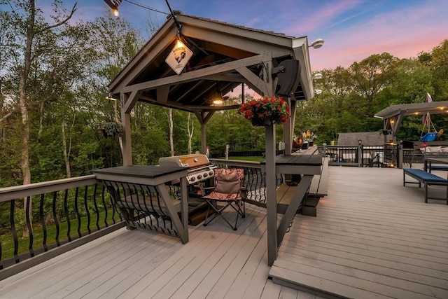 8 New Spencer Rd, Charlton, MA 01507 - deck at dusk featuring a gazebo, outdoor dining space, and view of scattered trees
