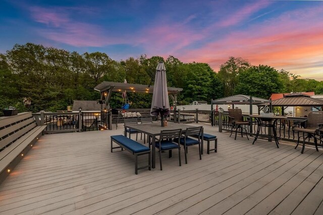 8 New Spencer Rd, Charlton, MA 01507 - wooden terrace with outdoor dining space, a gazebo, and view of wooded area