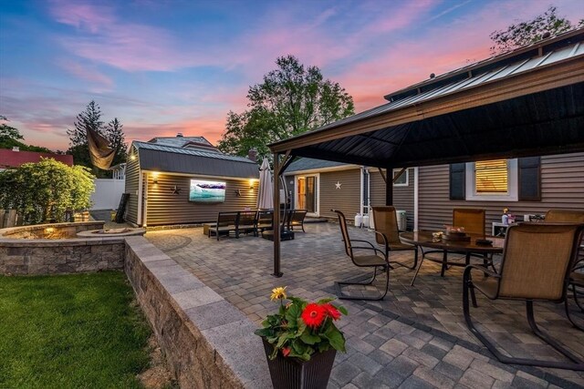 8 New Spencer Rd, Charlton, MA 01507 - view of patio with a gazebo, outdoor dining space, an outdoor fire pit, an outdoor structure, and fence