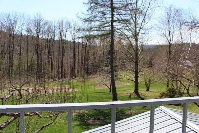 balcony featuring a forest view