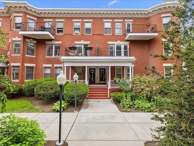 1 Auburn Ct Unit 1, Brookline, MA 02446 - view of front of house featuring a porch and brick siding