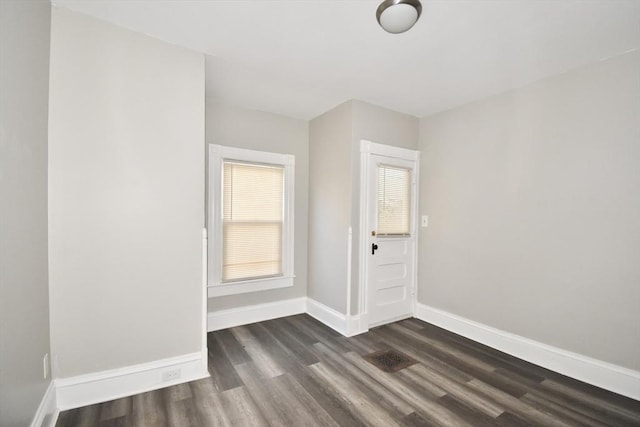 spare room with dark hardwood / wood-style floors