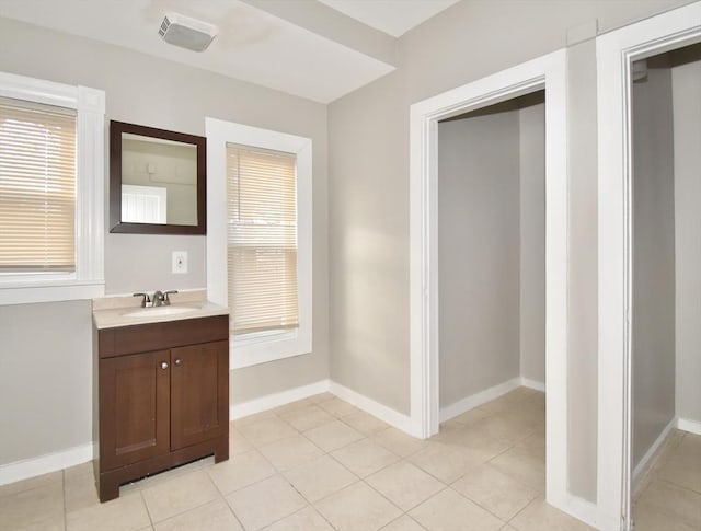 bathroom featuring tile patterned floors, vanity, and a healthy amount of sunlight