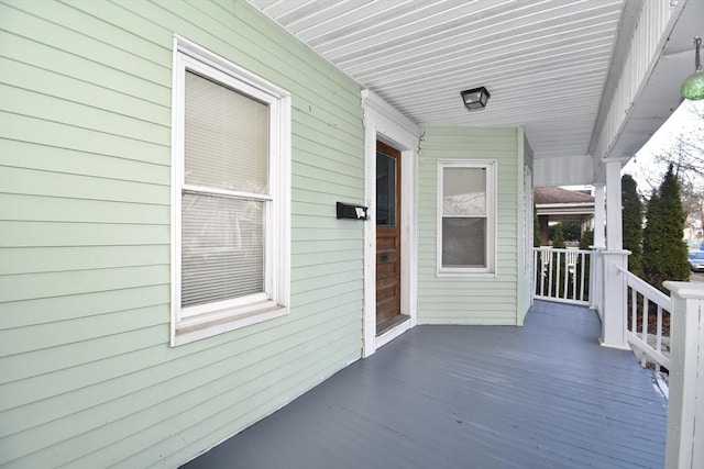 wooden terrace featuring covered porch