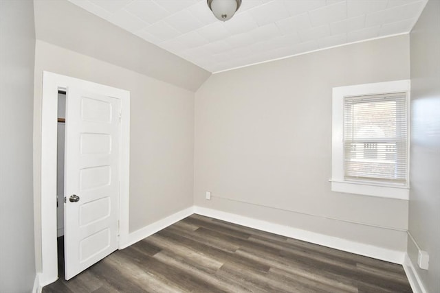 unfurnished room with dark wood-type flooring