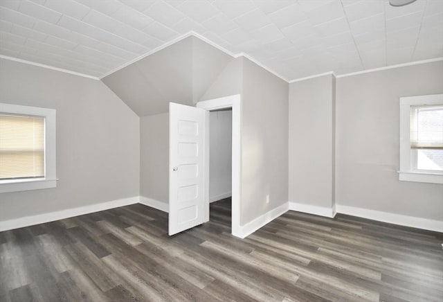 bonus room with dark wood-type flooring and lofted ceiling