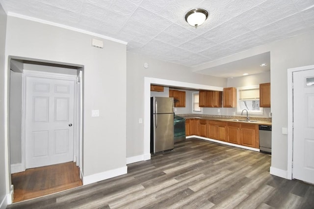 kitchen with stainless steel appliances, dark hardwood / wood-style floors, and sink