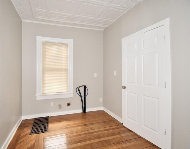 unfurnished room with wood-type flooring