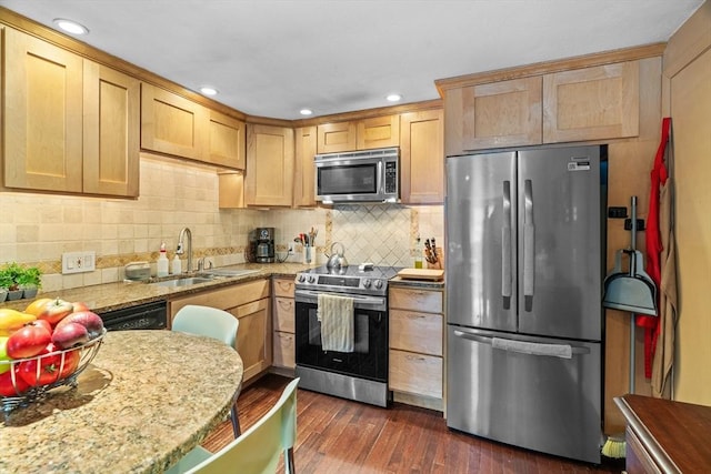 kitchen with decorative backsplash, dark wood finished floors, appliances with stainless steel finishes, light brown cabinets, and a sink