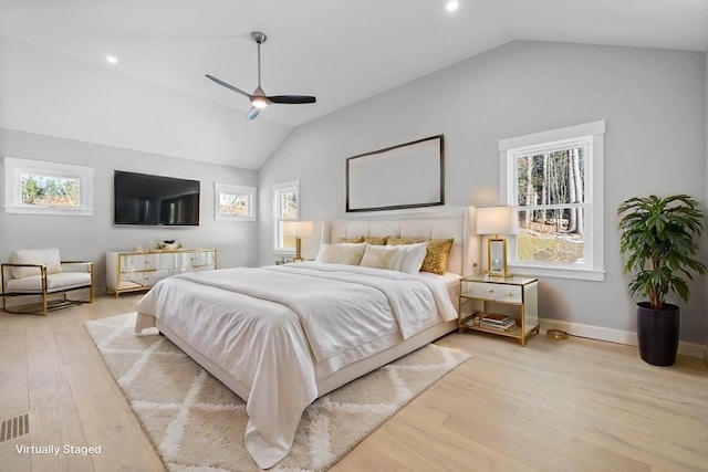 bedroom with multiple windows, light hardwood / wood-style floors, and vaulted ceiling