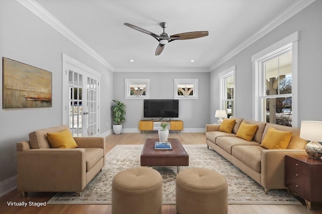 living room featuring french doors, light hardwood / wood-style floors, ceiling fan, and ornamental molding