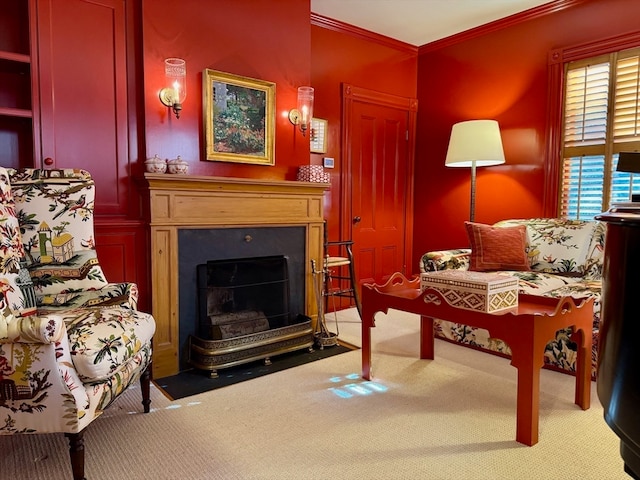 sitting room with carpet flooring and crown molding