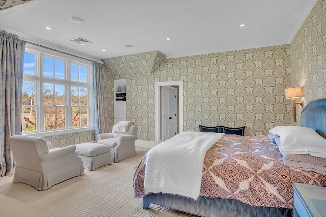 bedroom featuring a large fireplace and crown molding