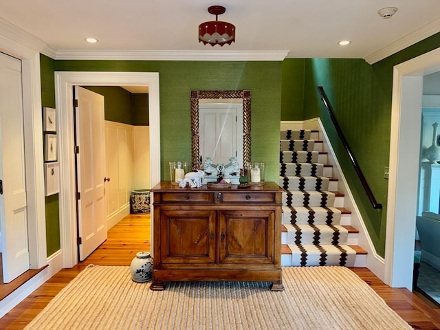 interior space with light hardwood / wood-style floors and ornamental molding