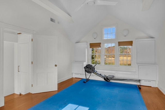 exercise room featuring high vaulted ceiling, hardwood / wood-style flooring, and ceiling fan