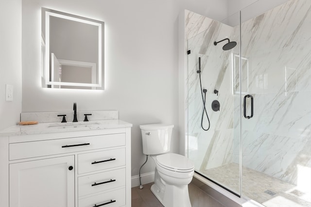 bathroom with vanity, toilet, and walk in shower