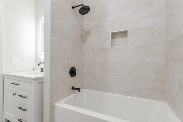 bathroom with vanity and tiled shower / bath combo