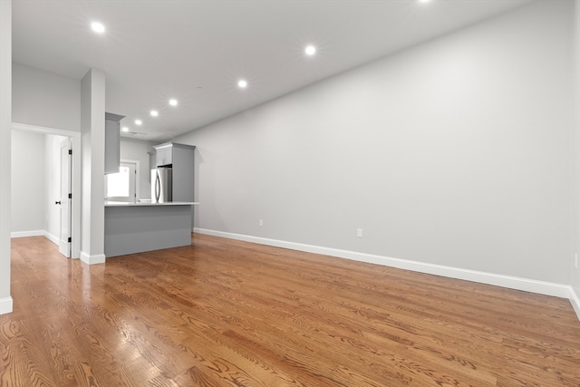 unfurnished living room featuring hardwood / wood-style flooring