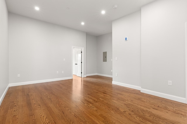 spare room featuring hardwood / wood-style floors and electric panel