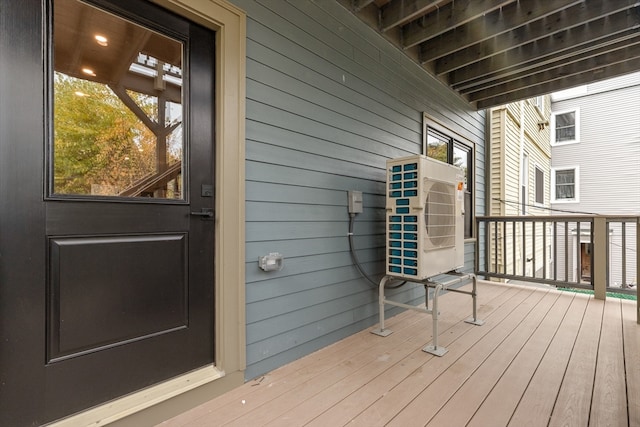 wooden deck featuring ac unit