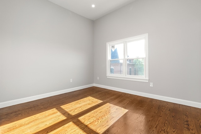 unfurnished room with hardwood / wood-style flooring