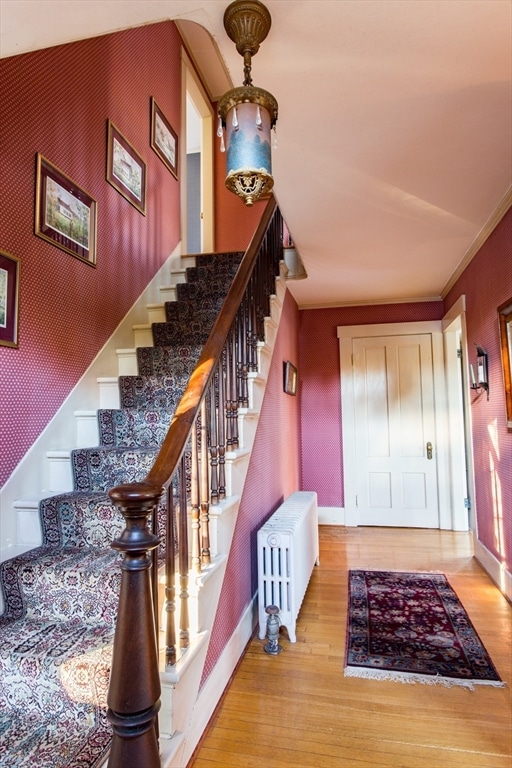 stairs with radiator and wood-type flooring