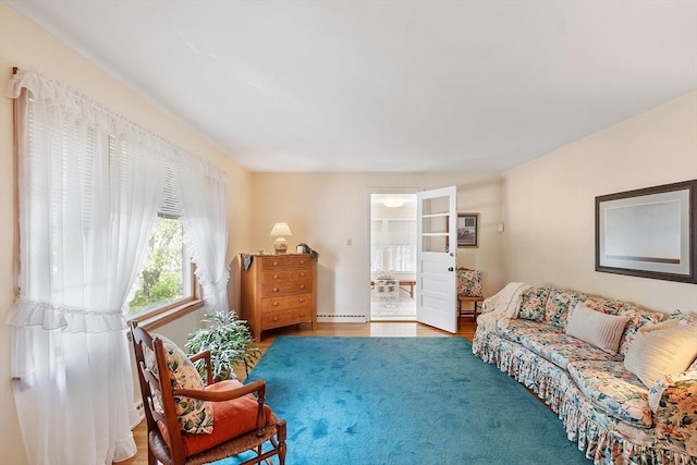 890 Westford St, Lowell, MA 01850 - living room with wood finished floors and a baseboard heating unit