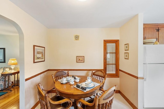 890 Westford St, Lowell, MA 01850 - dining space with arched walkways and light wood-style floors