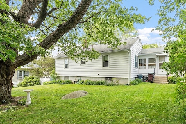 890 Westford St, Lowell, MA 01850 - back of house with a yard and a shingled roof