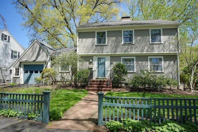 colonial home featuring fence, an attached garage, a front lawn, entry steps, and a chimney