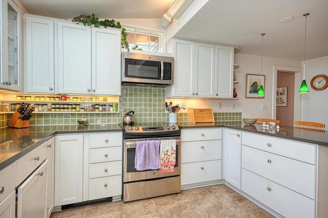 kitchen featuring stainless steel appliances, dark countertops, decorative backsplash, and white cabinetry