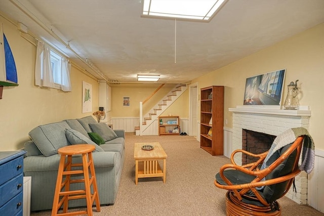 living room featuring carpet flooring, a brick fireplace, and stairway