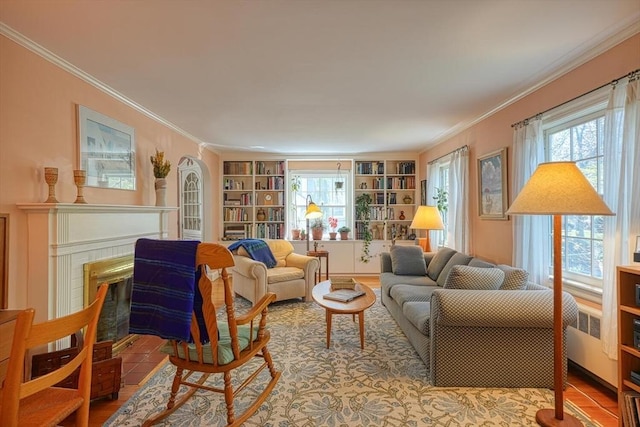 living area with ornamental molding, built in shelves, and a fireplace