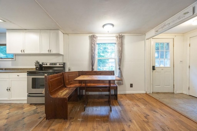 170 Walnut Rd, Wrentham, MA 02093 - kitchen with stainless steel electric range oven, wood-type flooring, and white cabinets