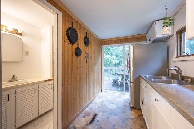 170 Walnut Rd, Wrentham, MA 02093 - kitchen with white cabinetry, healthy amount of natural light, wooden walls, and freestanding refrigerator