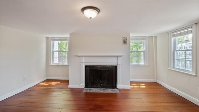 141 State St Unit 2, Newburyport, MA 01950 - unfurnished living room with wood-type flooring, a fireplace with flush hearth, and baseboards