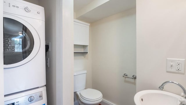 141 State St Unit 2, Newburyport, MA 01950 - half bathroom featuring stacked washer and clothes dryer, toilet, and a sink